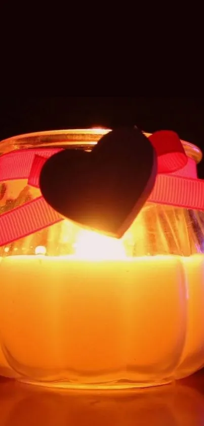 Heart adorned candle glows warmly.