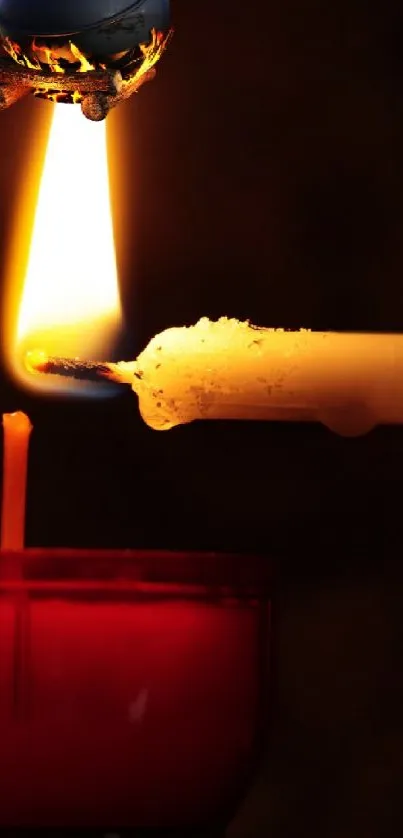 A warm candlelight flame in a cozy dim setting for phone wallpaper.