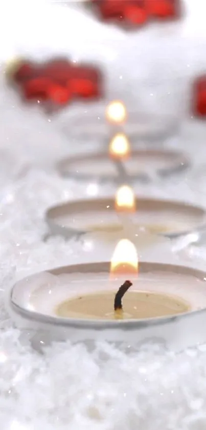 Candlelit winter scene with snow and red decor elements.