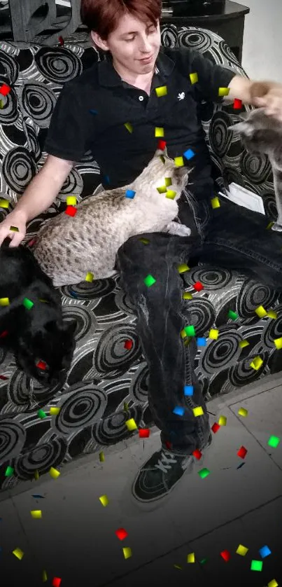 Person embracing multiple cats on a patterned sofa.