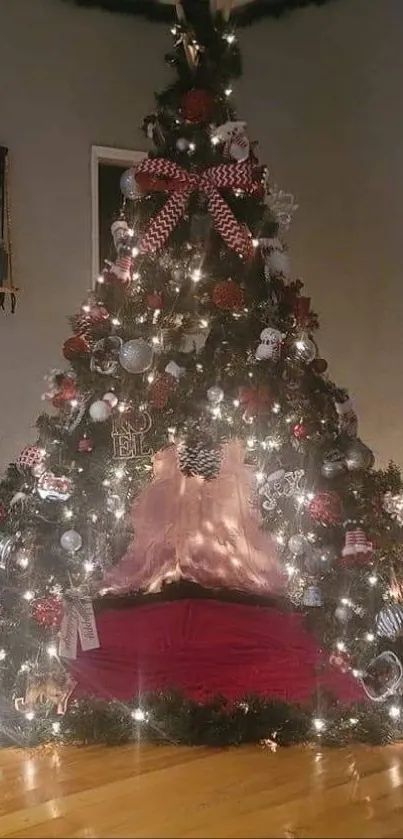 Cozy Christmas tree with red decor and glowing lights in a corner.