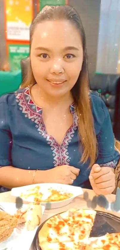 Woman enjoying meal with pizza and fried chicken in a cozy dining setting.