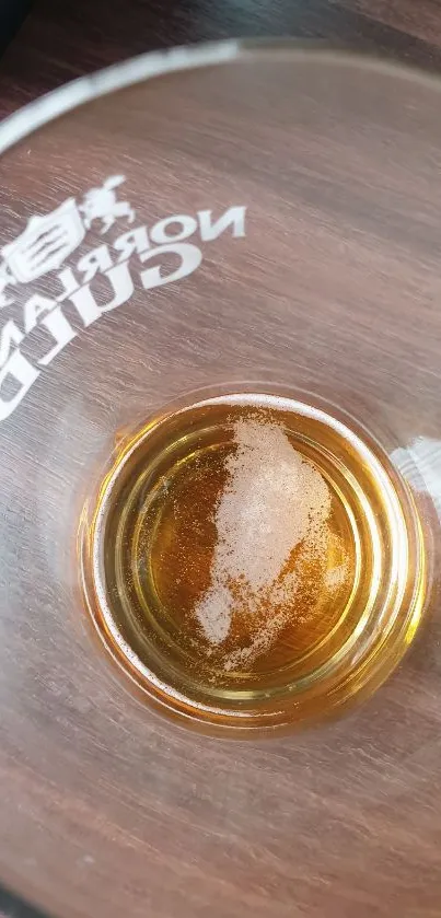 Top view of drink in glass on wooden table.