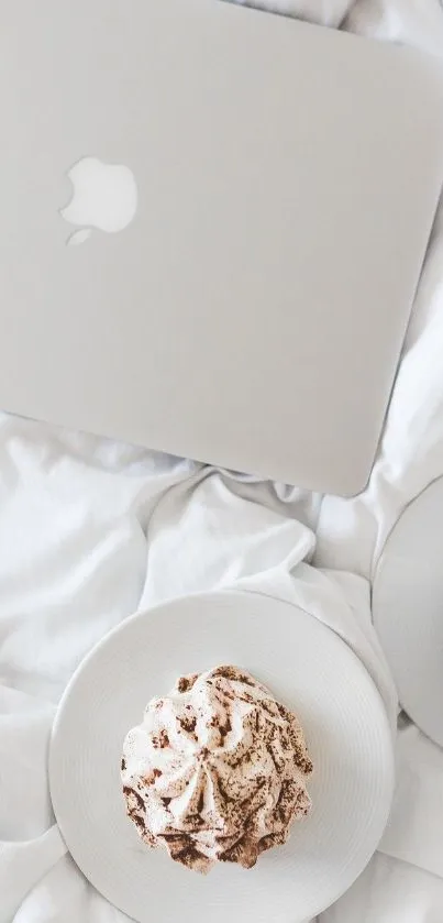 Cozy mobile wallpaper with laptop and coffee on white bedding.