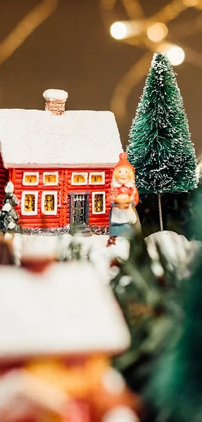 Red house in festive village setting with trees and lights.