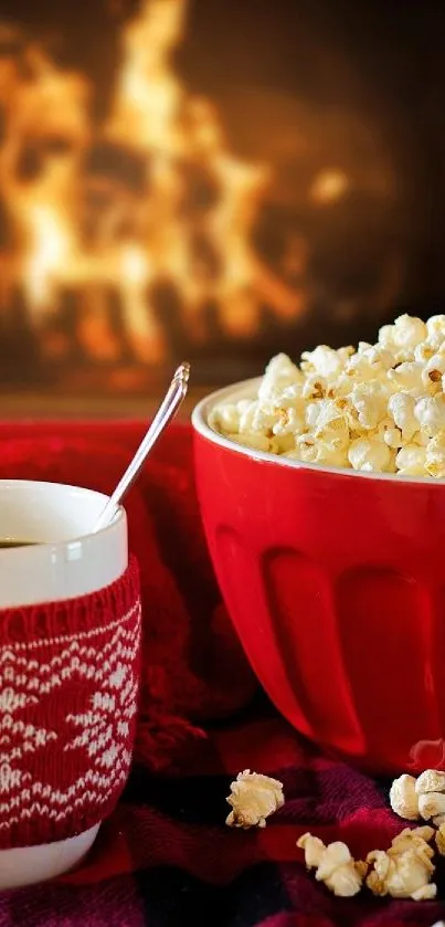 Cozy scene with a fireplace, red mug, and popcorn in a red bowl.