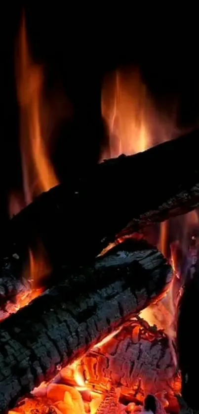 Warm fireplace with glowing flames and charred logs.