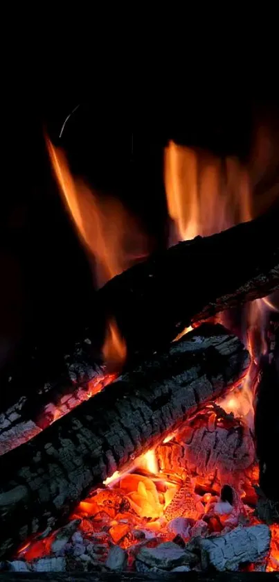 Warm flames and glowing firewood wallpaper.