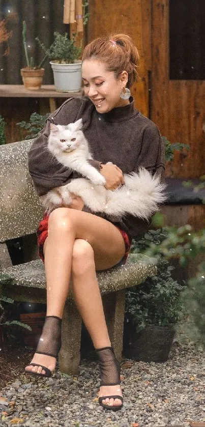 Woman with white cat in cozy garden setting.