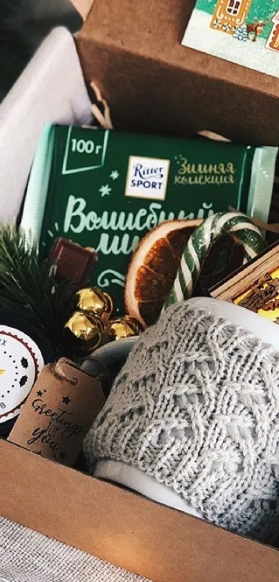 Cozy gift box with knitted mug in a festive scene.