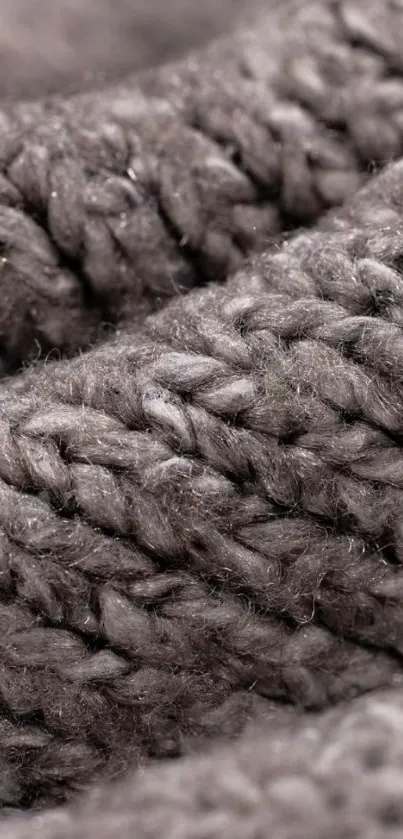 Close-up of grey knitted fabric texture mobile wallpaper.