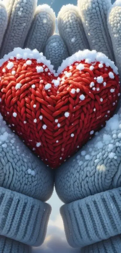 Knitted red heart held in cozy winter gloves.