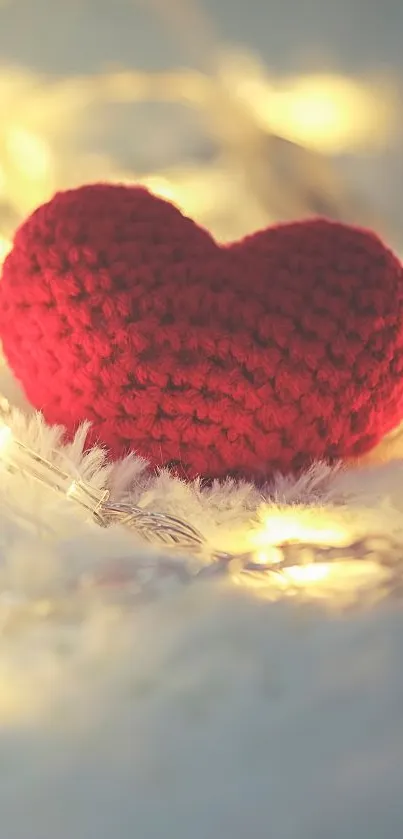 Knitted red heart with fairy lights background.