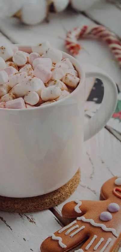 Cup of hot cocoa with marshmallows and gingerbread cookie on a wooden table.