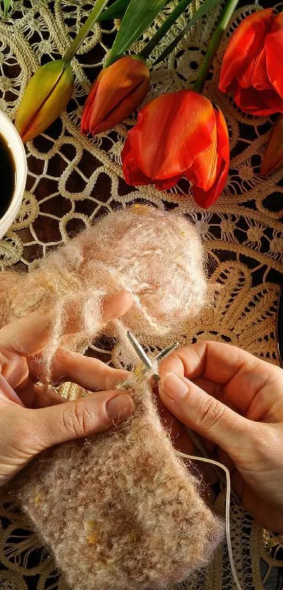 Knitting with coffee and tulips on lace table.