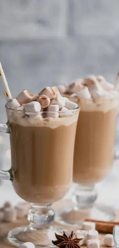 Two clear mugs of latte with marshmallows on top, set against a rustic backdrop.