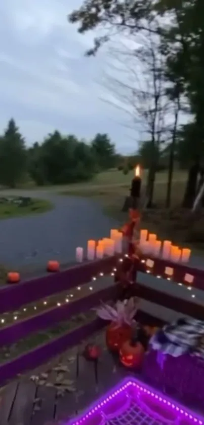 Cozy outdoor setup with candles and purple lights on a wooden deck.