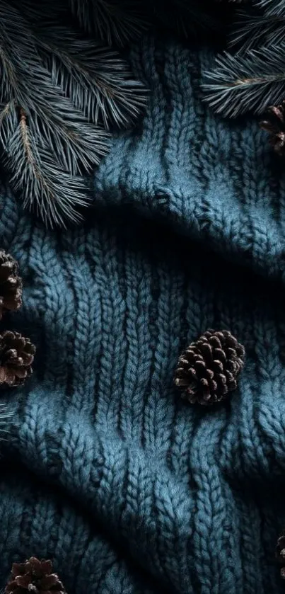 Pinecones on a blue knit fabric background wallpaper.