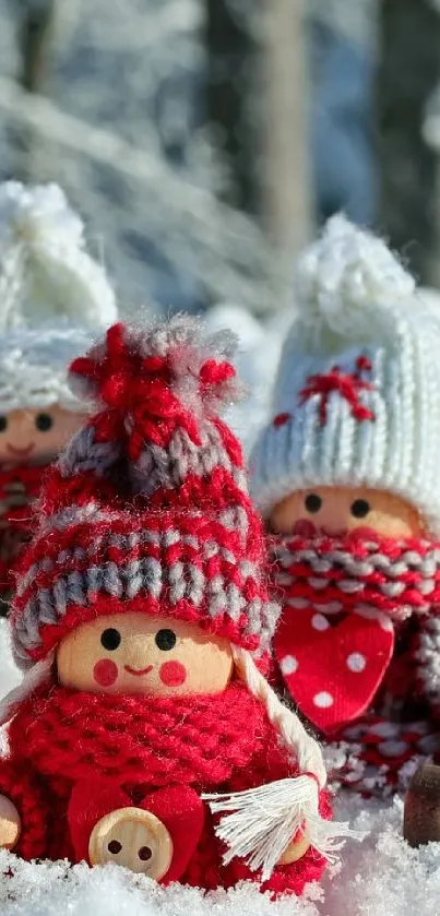 Three knit-dressed dolls in snowy landscape with red and white attire.