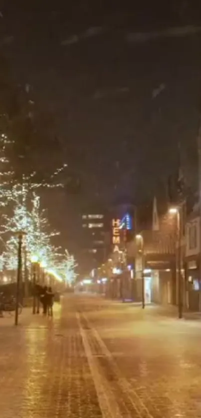 Snowy street at night with illuminated trees and warm amber lights.