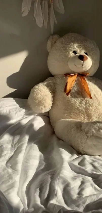 Cozy teddy bear with orange bow on a sunlit bed.