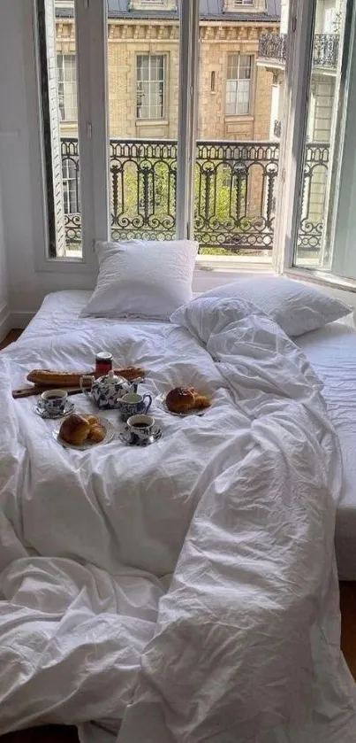 Cozy bed with breakfast in front of French windows in urban setting.