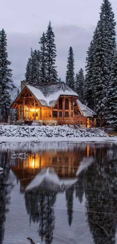 Wooden cabin by snowy lake with pine trees and reflection.