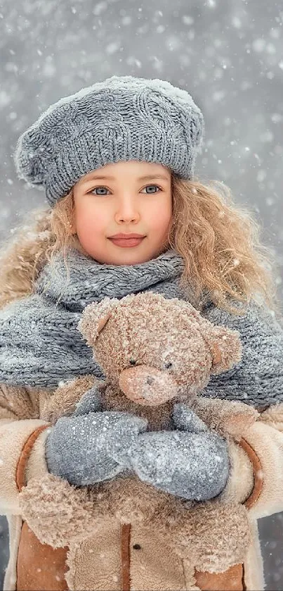 Child in winter attire holding a teddy bear with snowfall background.