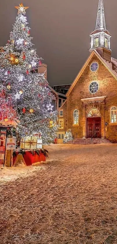 Snowy scene with Christmas tree and illuminated church at night.