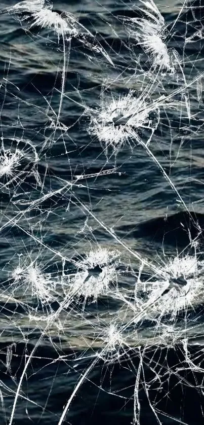 Cracked glass over dark ocean wallpaper for mobile.