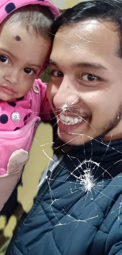 Cracked screen effect over a smiling person with child in pink.