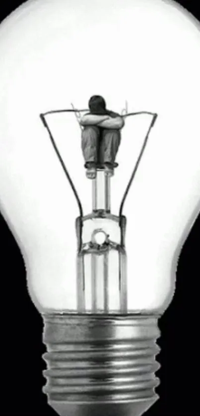 Creative wallpaper with person inside a light bulb, symbolizing ideas and innovation.