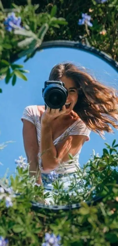 Mirror reflection with camera, surrounded by nature.