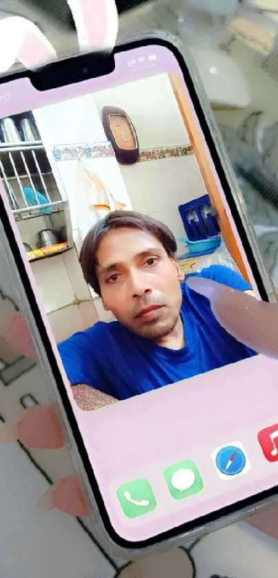 A hand holding a smartphone with a creative screen wallpaper.