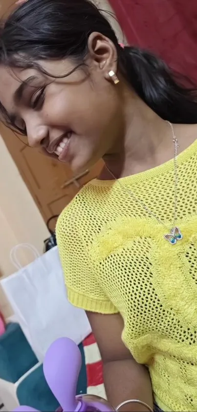 Smiling girl in yellow top indoors