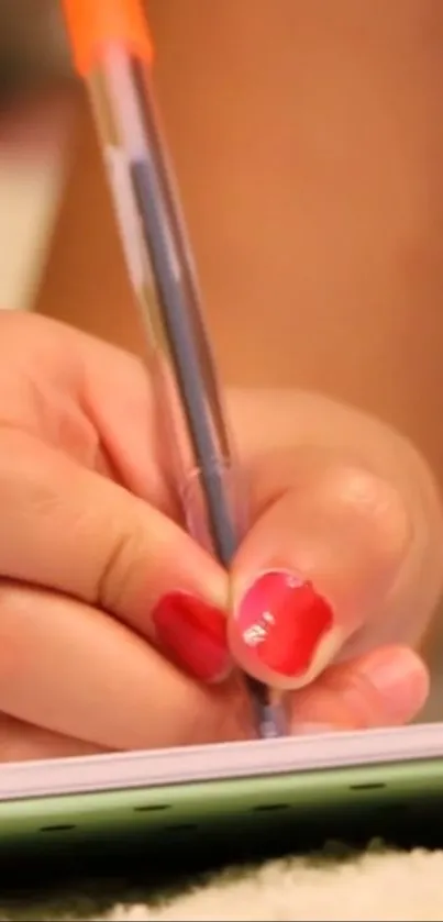 Close-up of a hand writing with a pen, showcasing creativity.