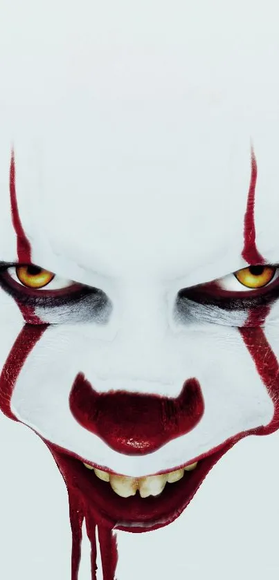 Eerie clown face with red makeup and yellow eyes on white background.