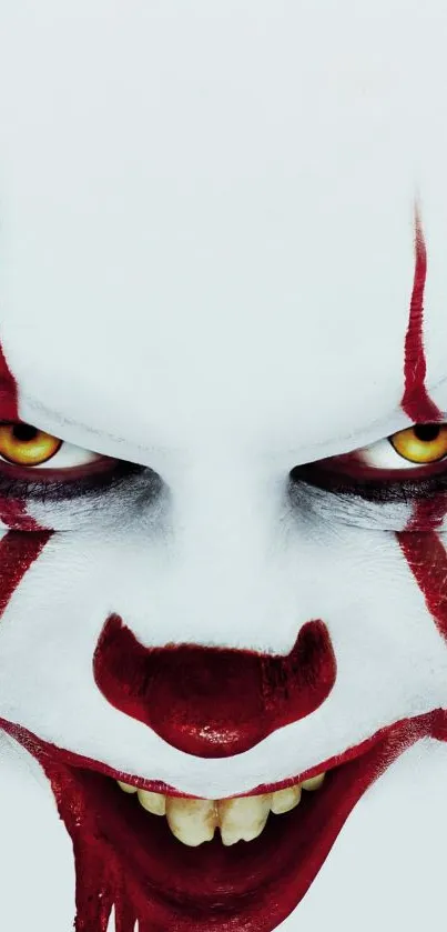 Creepy clown face with red makeup and intense eyes on mobile wallpaper.