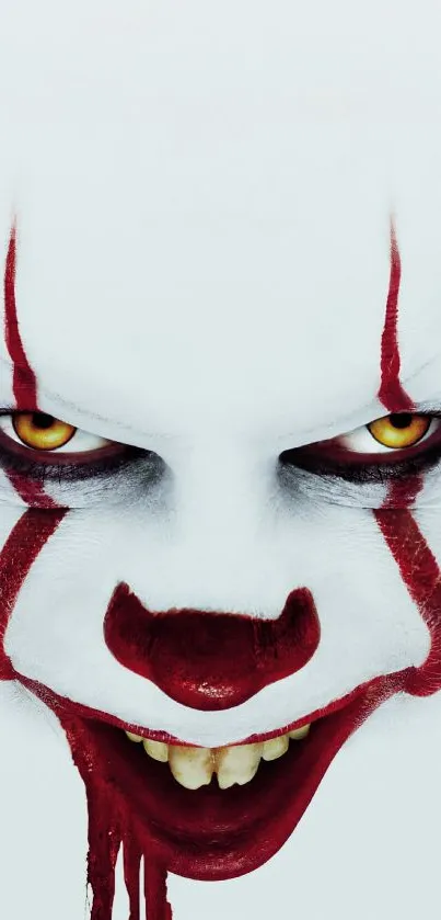 Creepy clown face with red makeup and piercing eyes, perfect for horror themes.