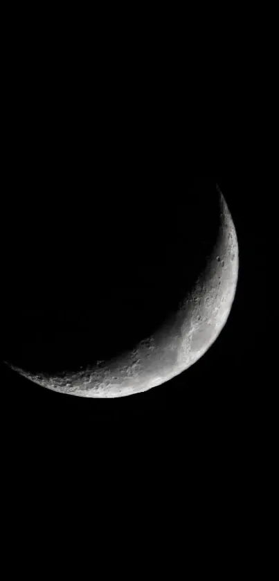 Crescent moon on a dark background, minimalist night sky wallpaper.