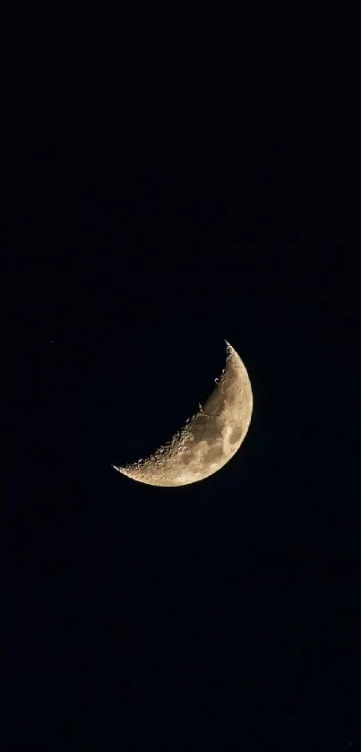 Crescent moon against a dark night sky, perfect for mobile wallpaper.