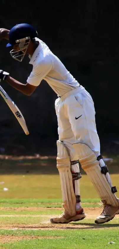 Cricket player in action on the field, wearing white uniform.