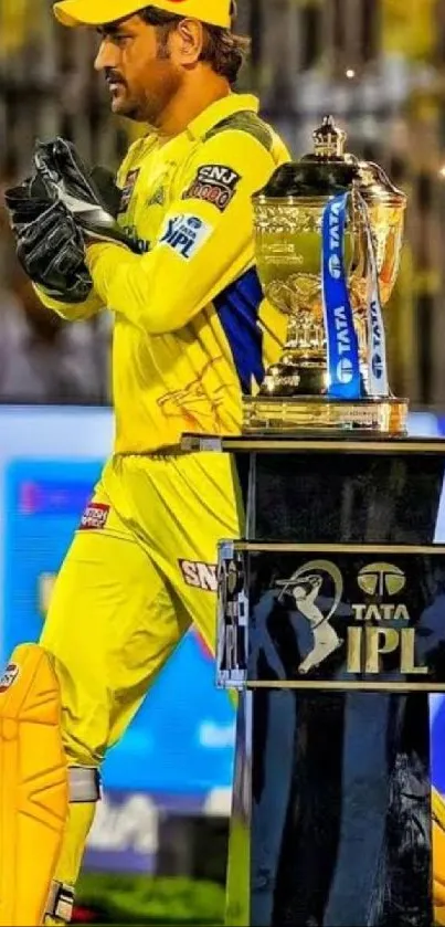 Cricket player in yellow with IPL trophy.