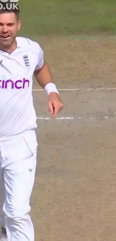 Cricket player celebrating on field in white uniform.