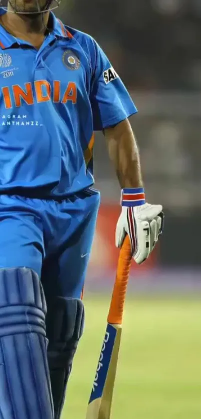 Cricket player in blue jersey on field with bat.