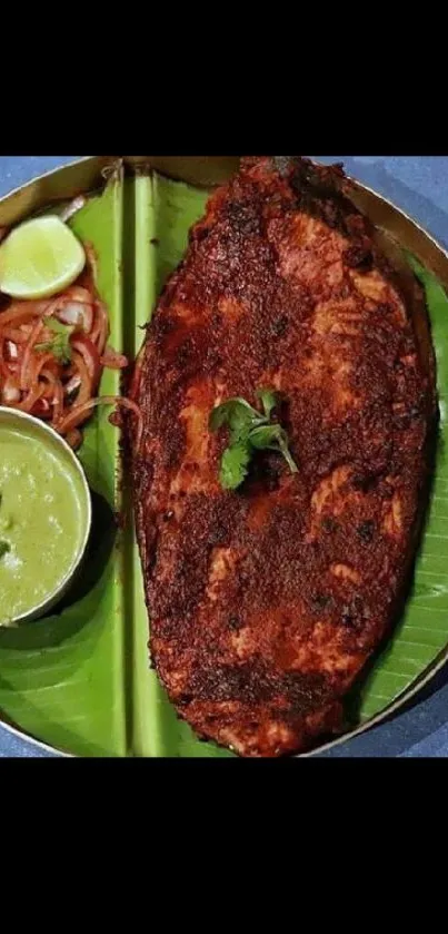 Crispy fish and mint chutney on banana leaf plate.