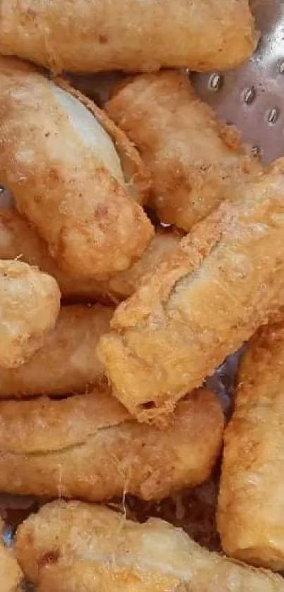 Golden brown crispy fried bananas in a colander.