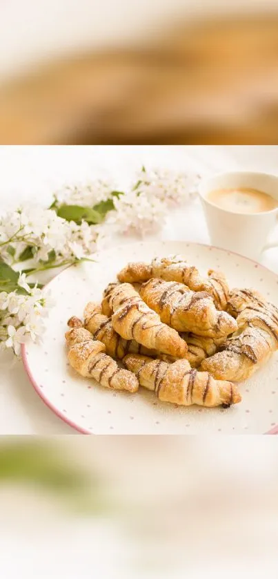 Plate of croissants with coffee and white flowers.