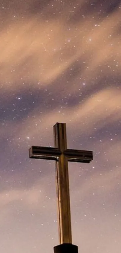 Silhouette of a cross under a starry, cloud-filled night sky.