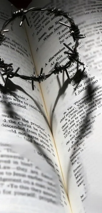 Crown of thorns casting a shadow on an open book in grayscale.
